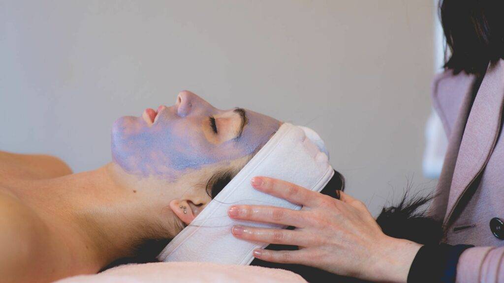 A client receiving acne treatment in the Estie Co. Clear Skin Program